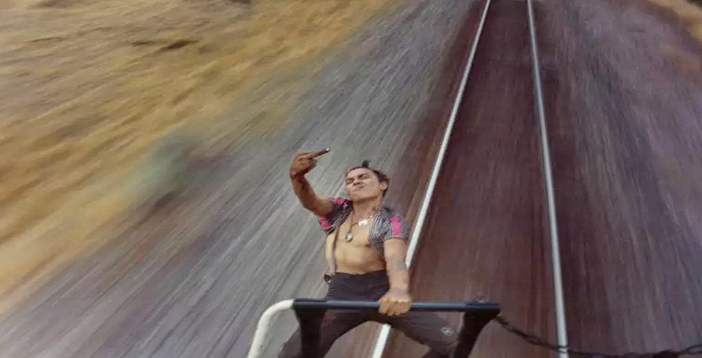 Train hopper flips the bird while hanging off the back of a moving train